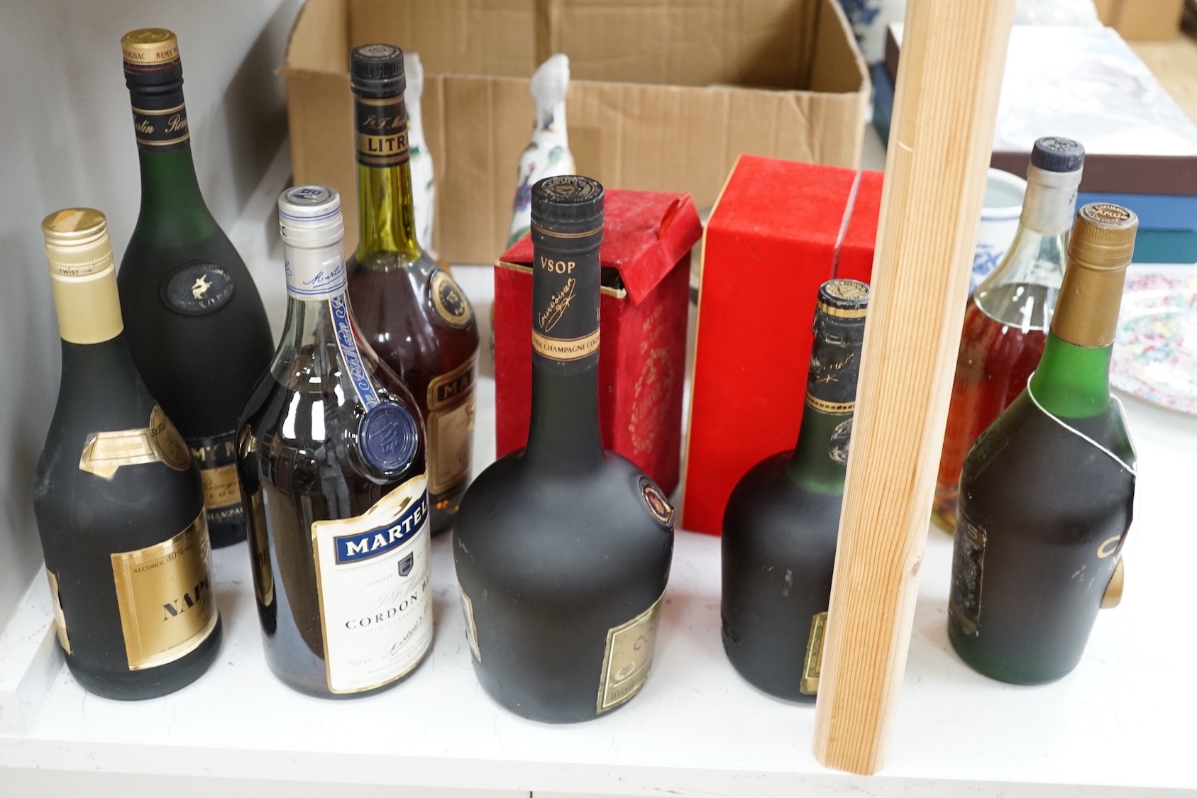 Four 1 litre bottles of cognac including Martell Cordon Bleu, Courvoisier, Martell and Remy Martin together with six smaller bottles of cognac including Martell Cordon Bleu, Camus Napoleon, Courvoisier, Napoleon, Gran Du